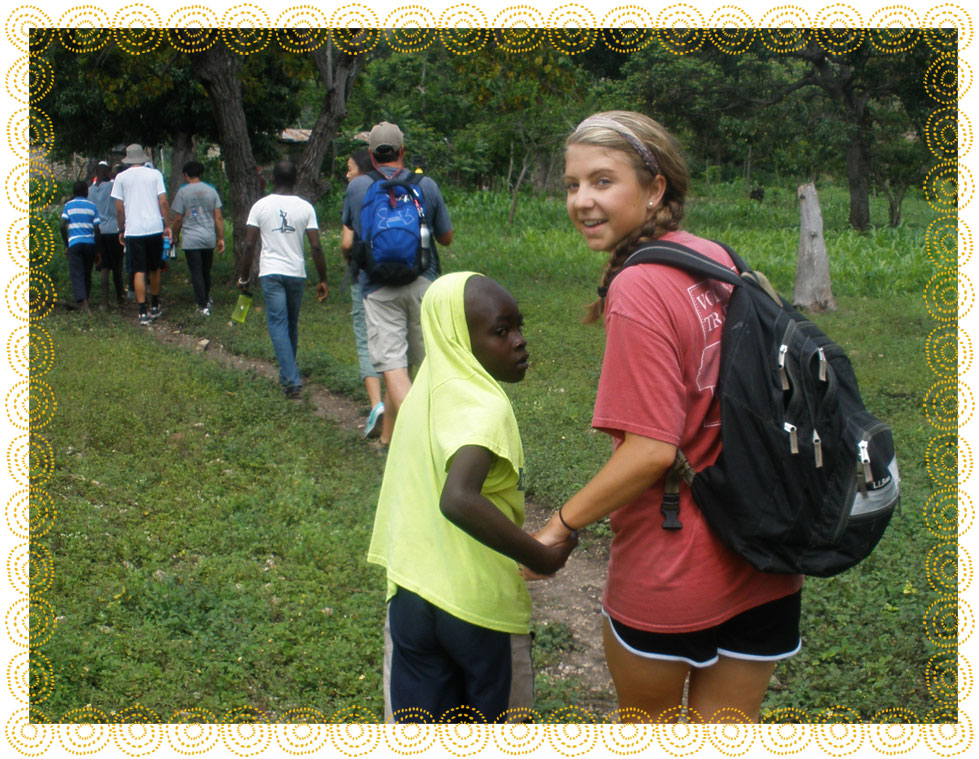 A student walking with a local young boy