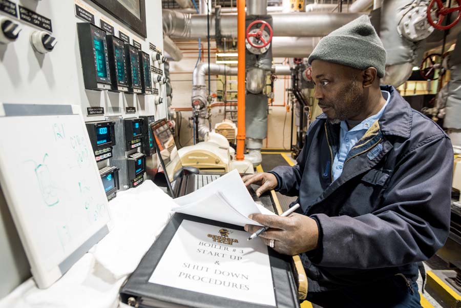 Michael Herriott, stationary engineer, researches timetables for chemical testing.