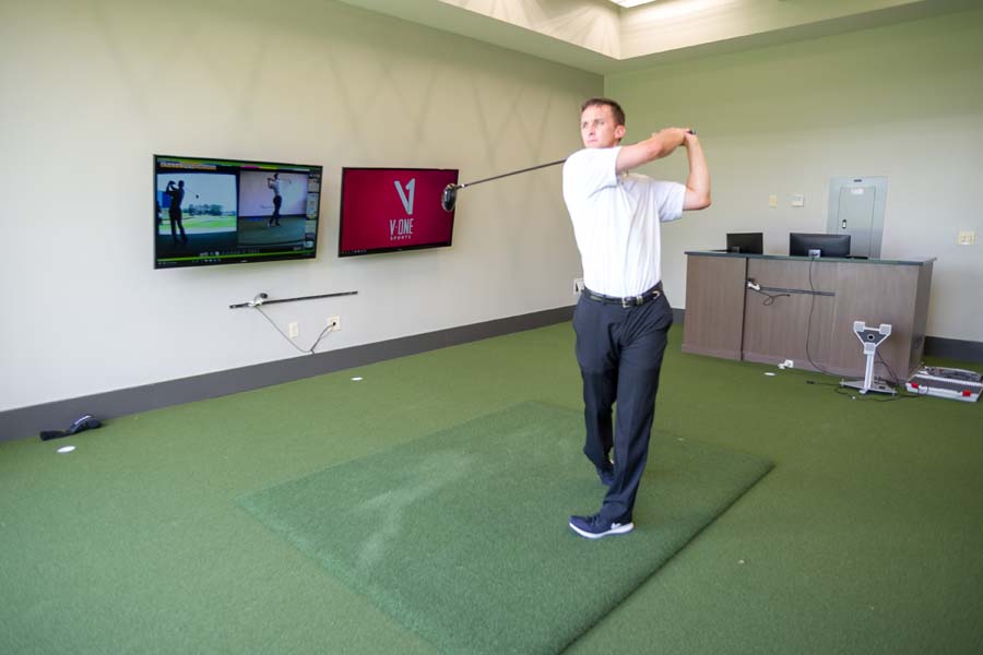 Assistant Golf Coach Drew McGee in the Matt Kuchar Teaching Center at Noonan Golf Facility.