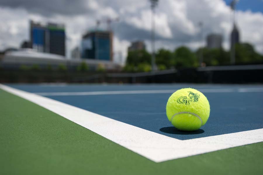 Tennis balls are branded with the interlocking GT and Buzz.