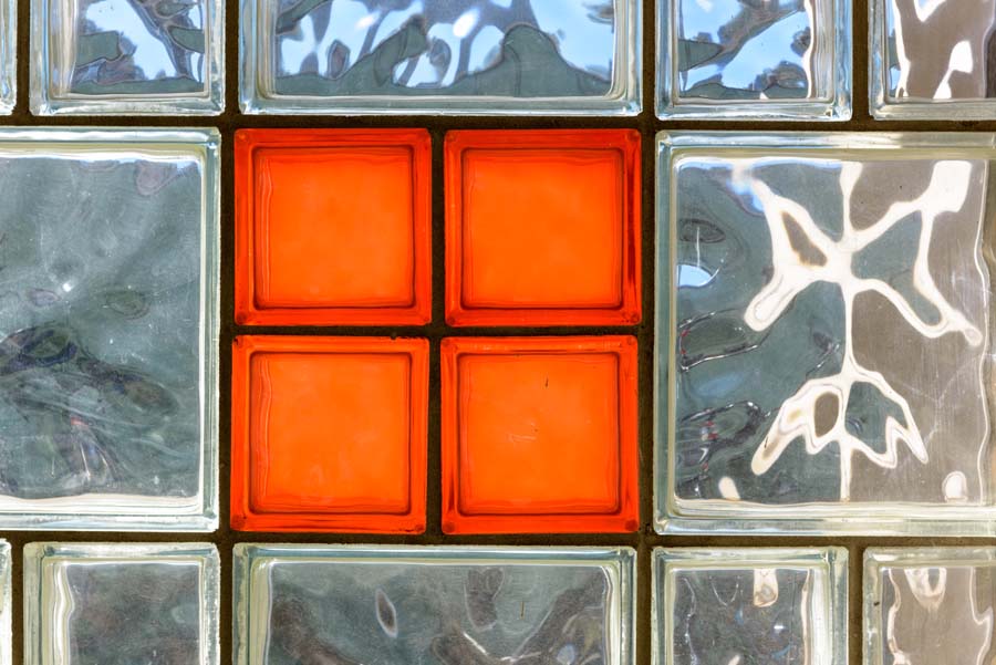 The design of the Blake R. Van Leer Building includes a screen wall of perforated block, some infilled with colored or tinted glass.