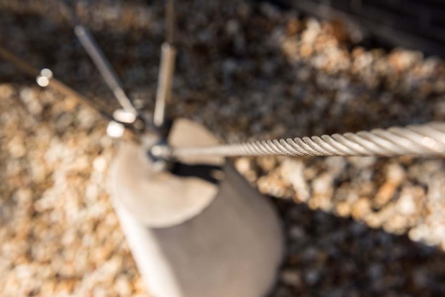 Tension cables converge on a truncated concrete cone at the Joseph Brown Whitehead Building.