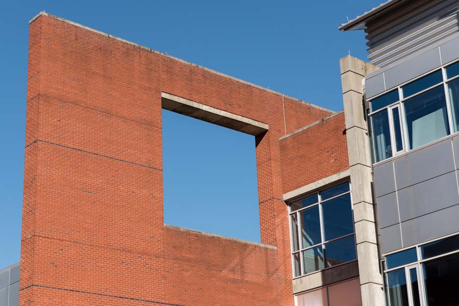 Wall planes mix open and glazed, solid and interpenetrating rectangles at the J. Erskine Love Jr. Manufacturing Building.