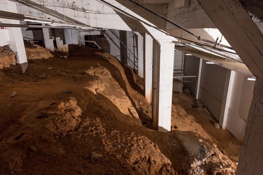 The renovated West Stands are larger than the original stands, which ended at the brick wall.