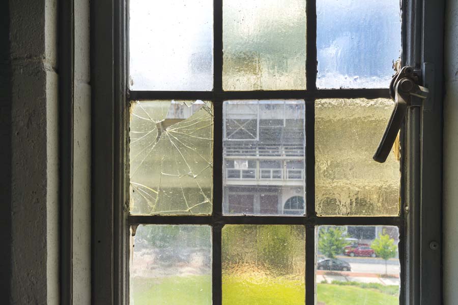 A close-up of one of the stained glass windows, with a broken pane. Hidden Georgia Tech Daisy's Apartment