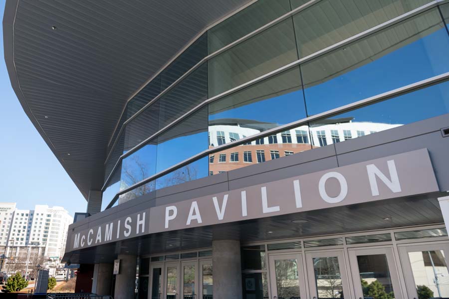 The mirrored windows of McCamish Pavilion reflect the buildings nearby.