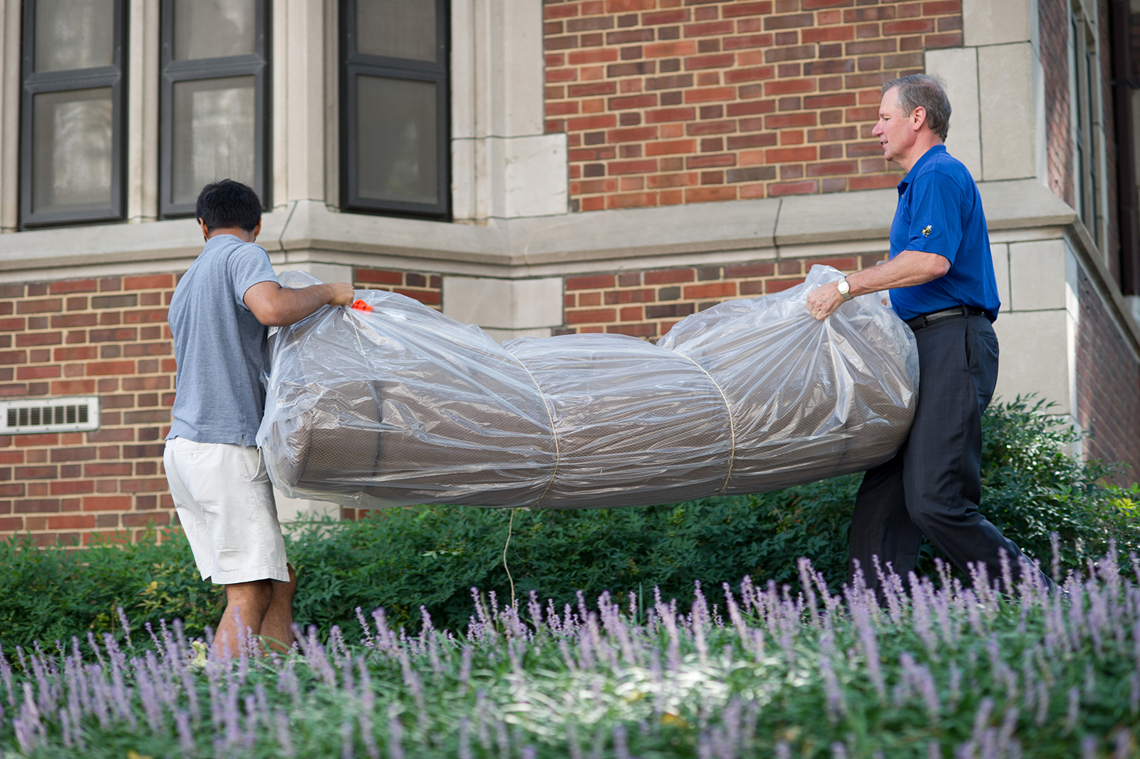 President G.P. "Bud" Peterson (right) helps with move-in in 2012