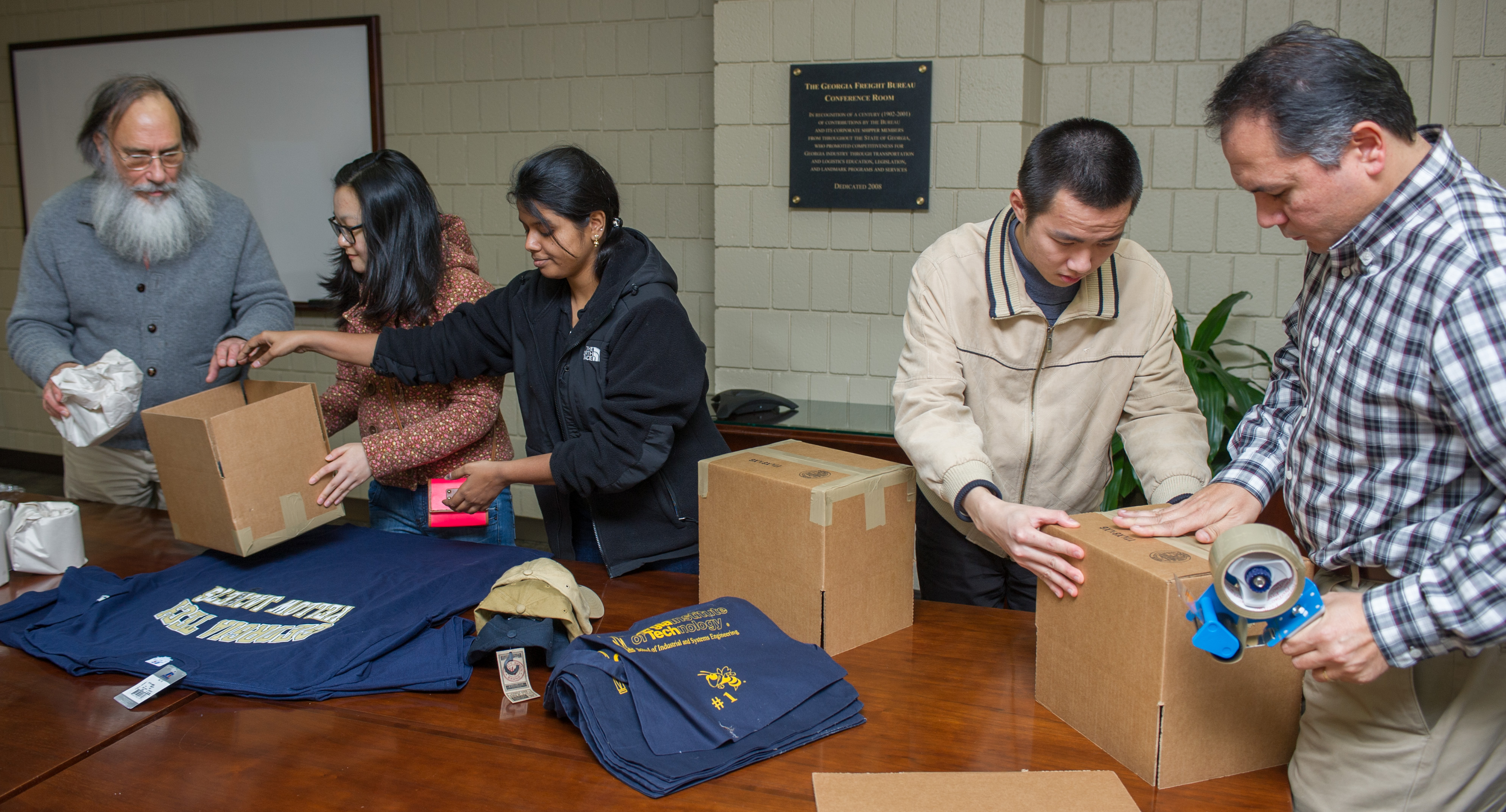 John Bartholdi, director of Global Research in the Supply Chain &amp; Logistics Institute, and students load packages for the Great International Package Race. 