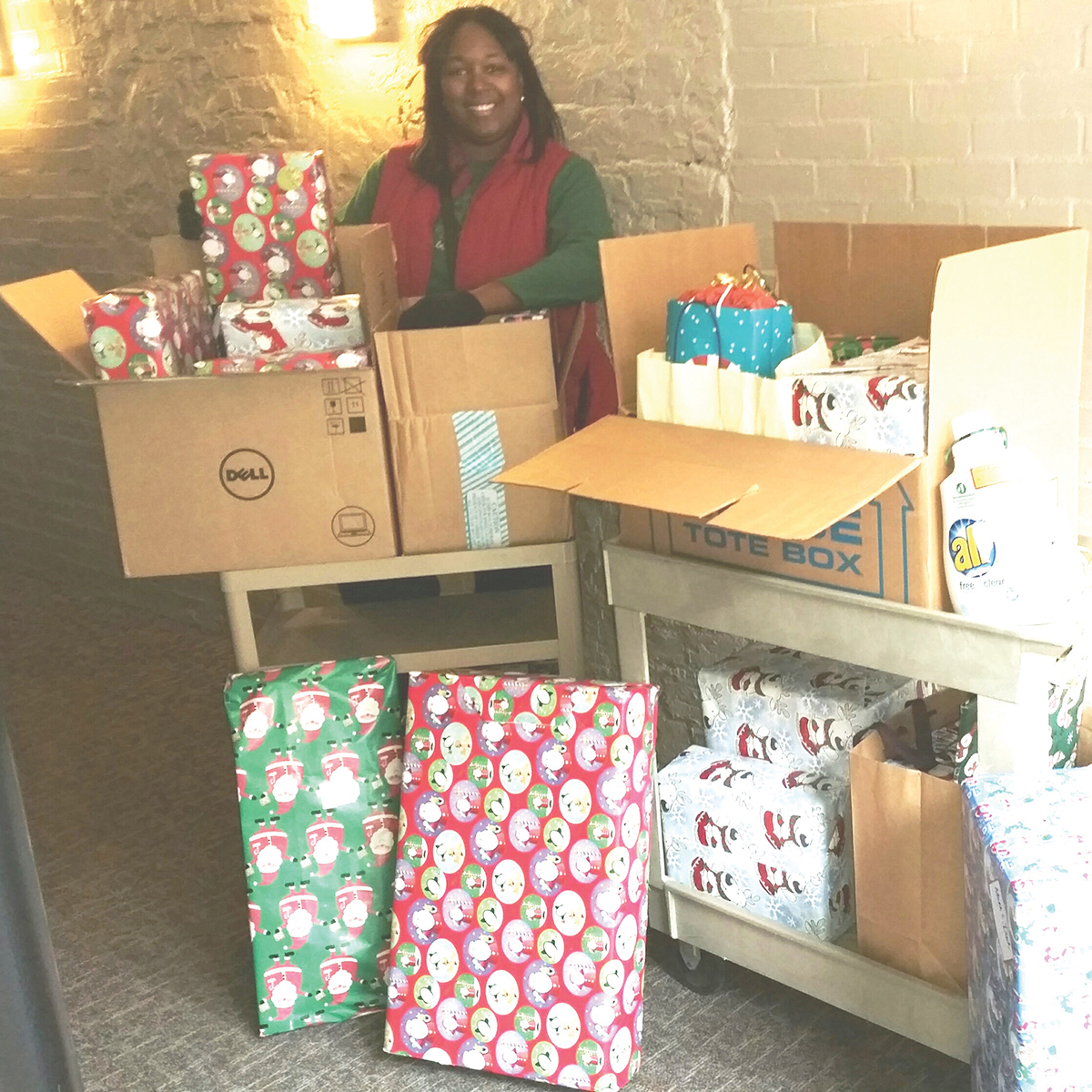 Nedra Ball, administrative manager in Strategic Consulting, with gift donations to be distributed to an employee’s family in the Department of Housing.
