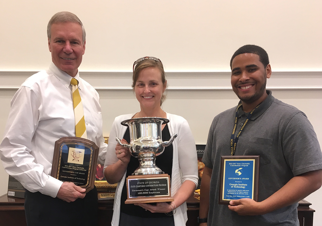 President G.P. “Bud” Peterson, Charitable Campaign Chair Leanne West, and Christopher Jackson, campaign volunteer, display the awards received for Tech employees’ contributions to the State Charitable Contributions Program. 