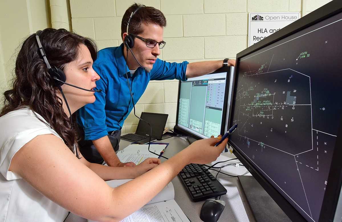 Marc Canellas and fellow researcher/co-author Rachel Haga, simulating air traffic controllers in a study of collision avoidance systems.
