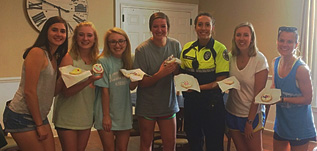 Georgia Tech Public Safety Officer Andrea Serrano decorates cookies with members of Alpha Gamma Delta as a part of the Adopt-A-Cop program.