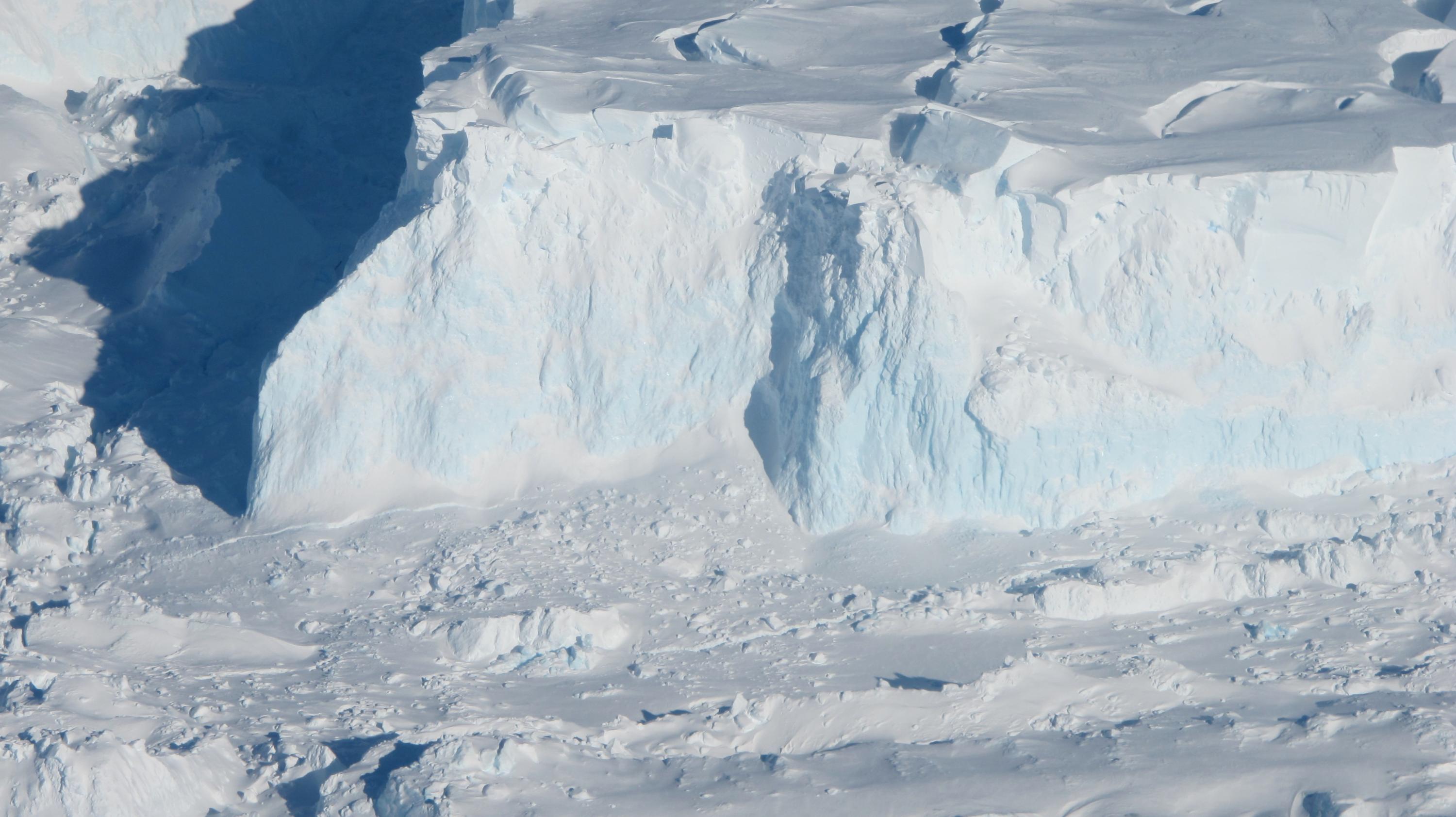 Thwaites Glacier's outer edge. As the glacier flows into the ocean, it becomes sea ice and drives up sea-level. Thwaites Glacier's ice is flowing particularly fast, and some researchers believe it may have already tipped into instability or be near that point, though this has not yet been established. Credit: NASA/James Yungel