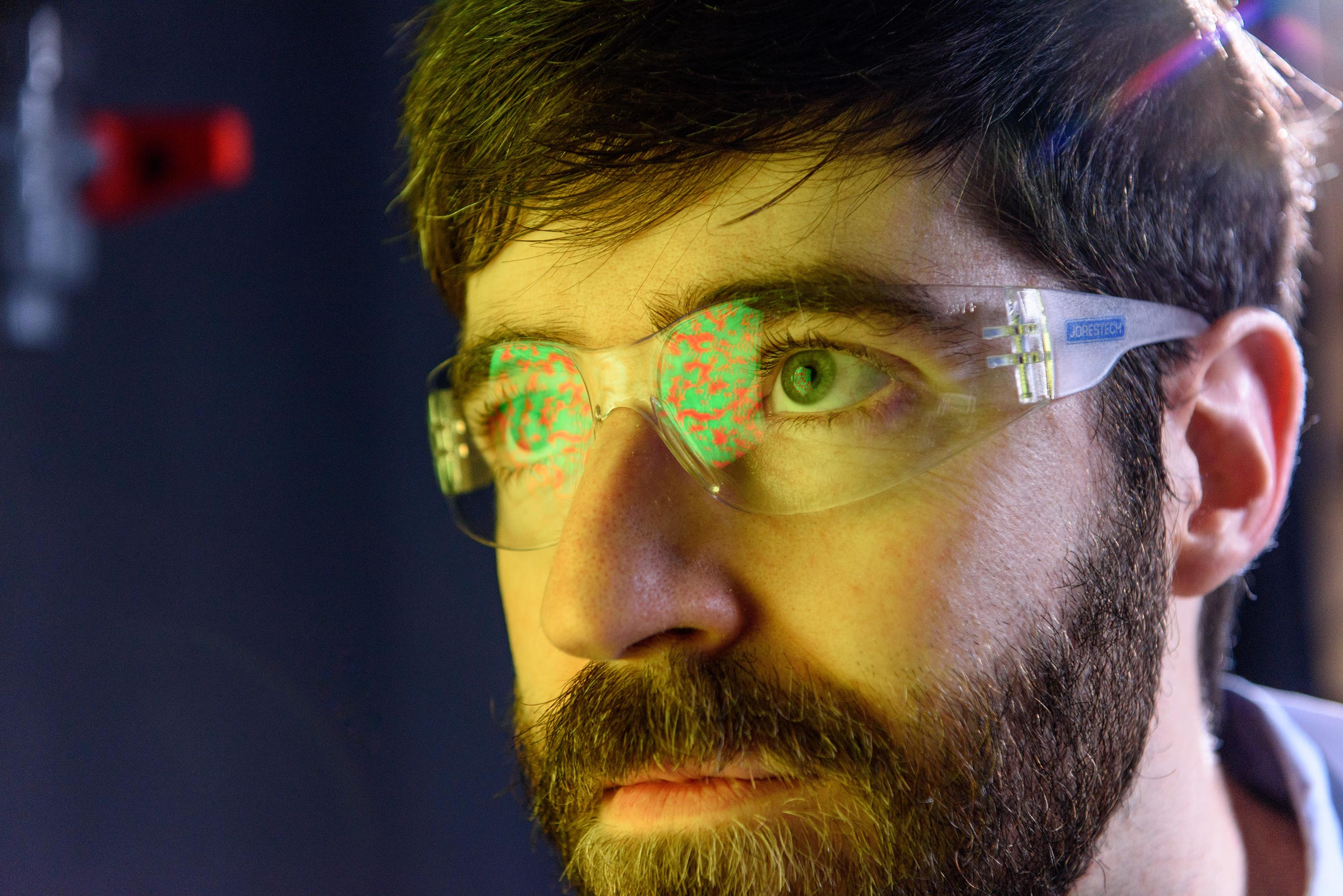 Physicist Peter Yunker applies mathematical equations to enemy colonies of dueling cholera bacteria to accurately predict the speed dynamics of their phase separation into divided territories, a process similar to the separation of oil and water. The equations were originally used to describe phase separate in materials, namely mixed metals (Model A equations). Credit: Georgia Tech / Rob Felt Physicist Peter Yunker applies mathematical equations to enemy colonies of dueling cholera bacteria to accurately predict the speed dynamics of their phase separation into divided territories, a process similar to the separation of oil and water. The equations were originally used to describe phase separate in materials, namely mixed metals (Model A equations). Credit: Georgia Tech / Rob Felt