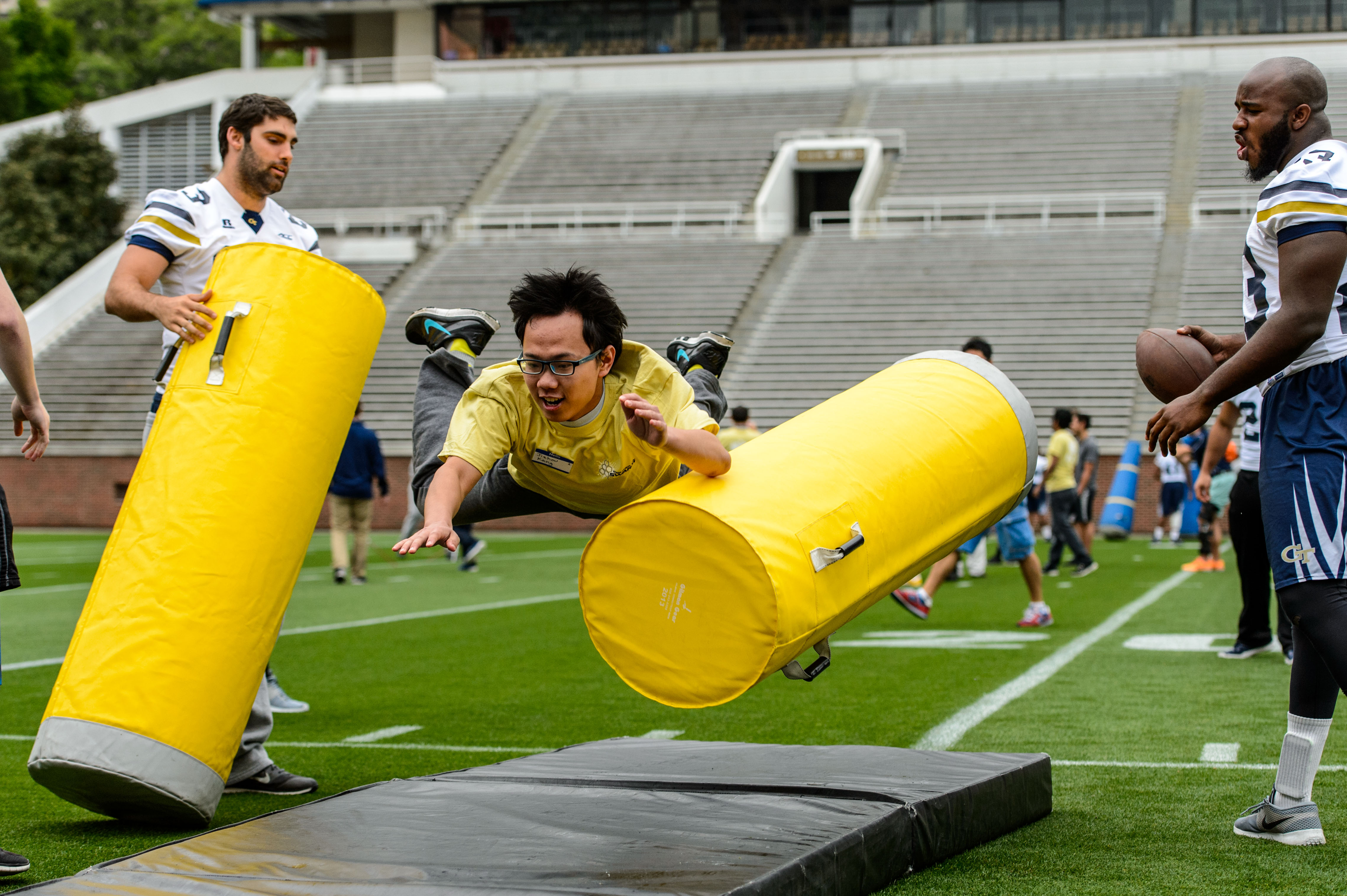 Students ran through eight different drills, including tackling dummies, during the International Football Clinic.