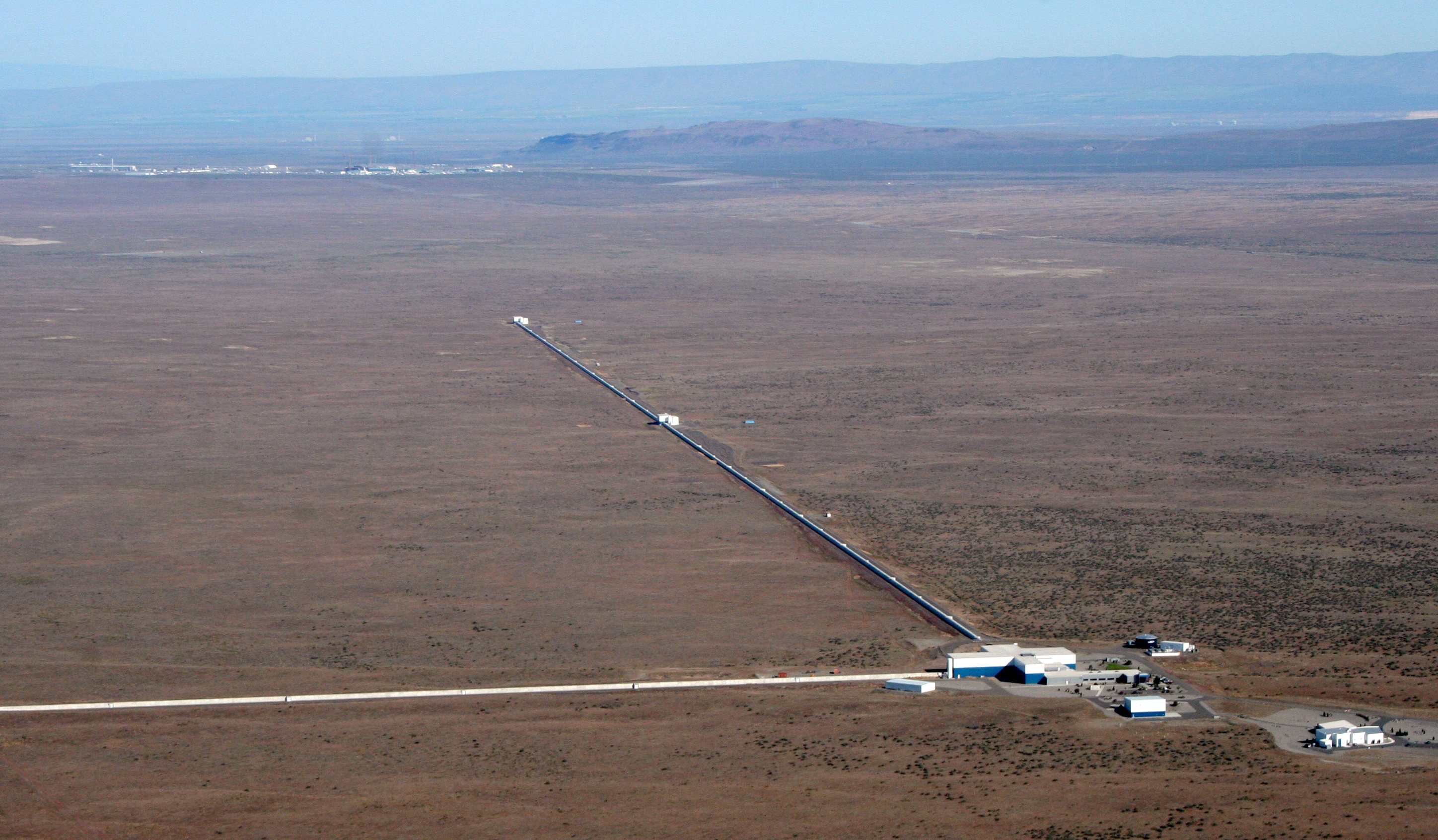 This aerial photograph shows the LIGO facility in Hanford, Washington. The two arms of the observatory are each four kilometers long. (Credit: LIGO Scientific Collaboration) This aerial photograph shows the LIGO facility in Hanford, Washington. The two arms of the observatory are each four kilometers long. (Credit: LIGO Scientific Collaboration)