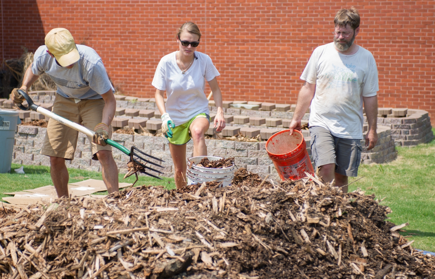 Students and faculty working on the campus garden