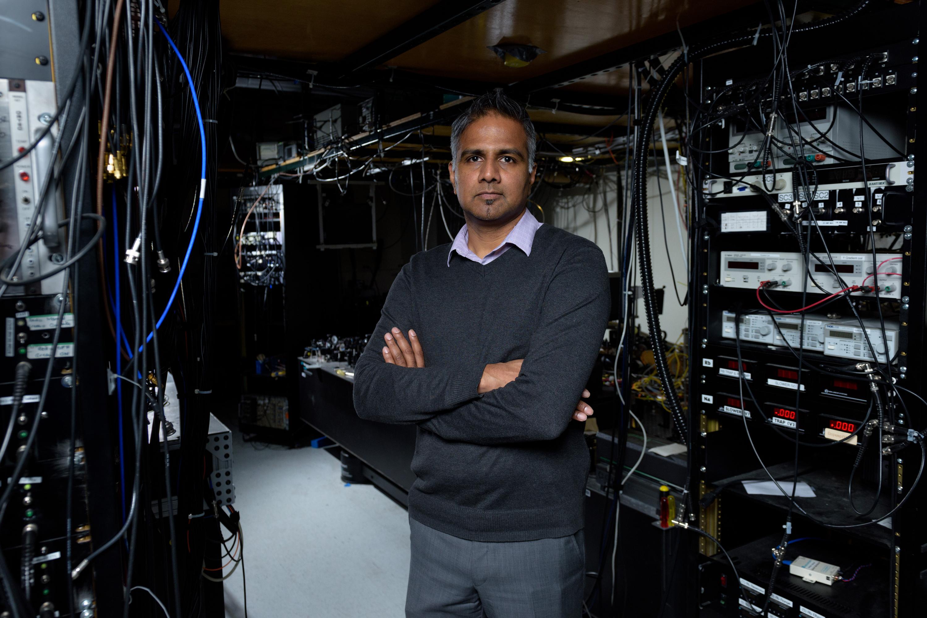 Chandra Raman, an associate professor in the Georgia Tech School of Physics, is shown in his laboratory with equipment used to study Bose-Einstein condensates. (Credit: Rob Felt, Georgia Tech).