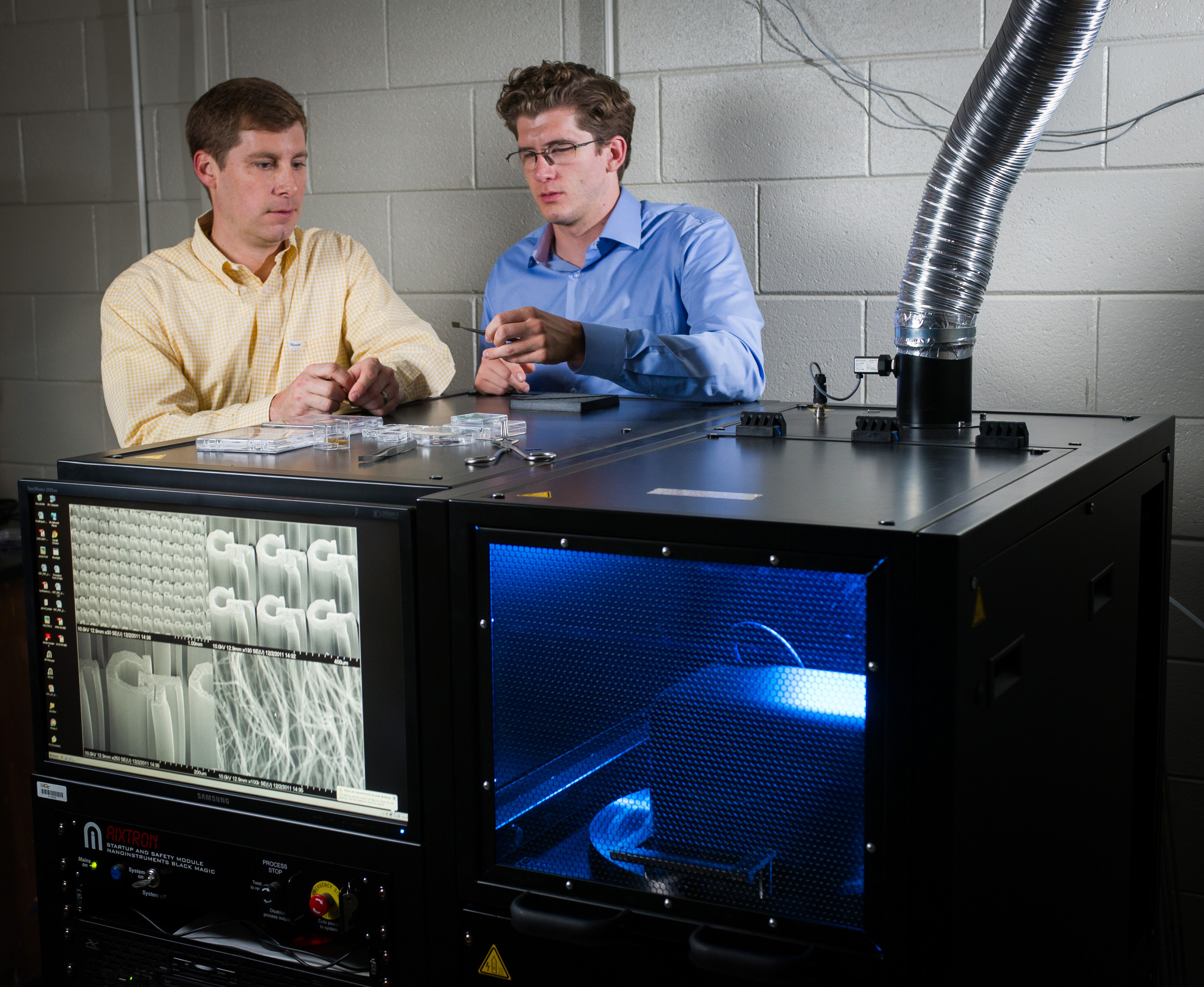 Georgia Tech researchers Jud Ready (left) and Graham Sanborn pose with equipment used to grow carbon nanotubes at the Georgia Tech Research Institute (GTRI) in Atlanta. The nanotubes are being tested for potential use in future electrically-powered ion propulsion systems. (Georgia Tech Photo: Rob Felt) Georgia Tech researchers Jud Ready (left) and Graham Sanborn pose with equipment used to grow carbon nanotubes at the Georgia Tech Research Institute (GTRI) in Atlanta. The nanotubes are being tested for potential use in future electrically-powered ion propulsion systems. (Georgia Tech Photo: Rob Felt)