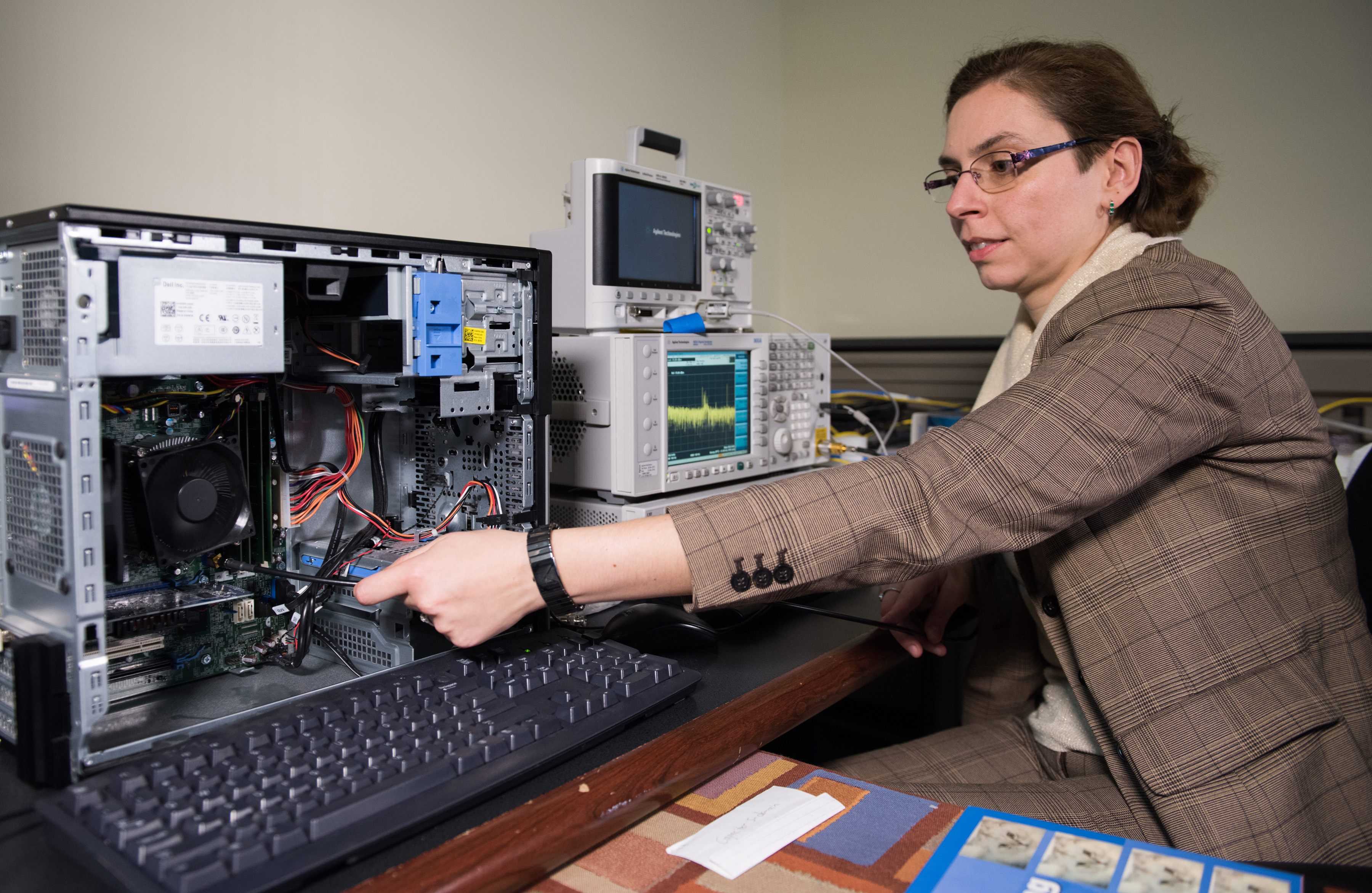 Georgia Tech researcher Alenka Zajic measures electromagnetic emissions from various components of a desktop computer. The researchers have studied emissions from desktop and laptop computers, as well as cellphones. (Credit: Rob Felt) Georgia Tech researcher Alenka Zajic measures electromagnetic emissions from various components of a desktop computer. The researchers have studied emissions from desktop and laptop computers, as well as cellphones. (Credit: Rob Felt)