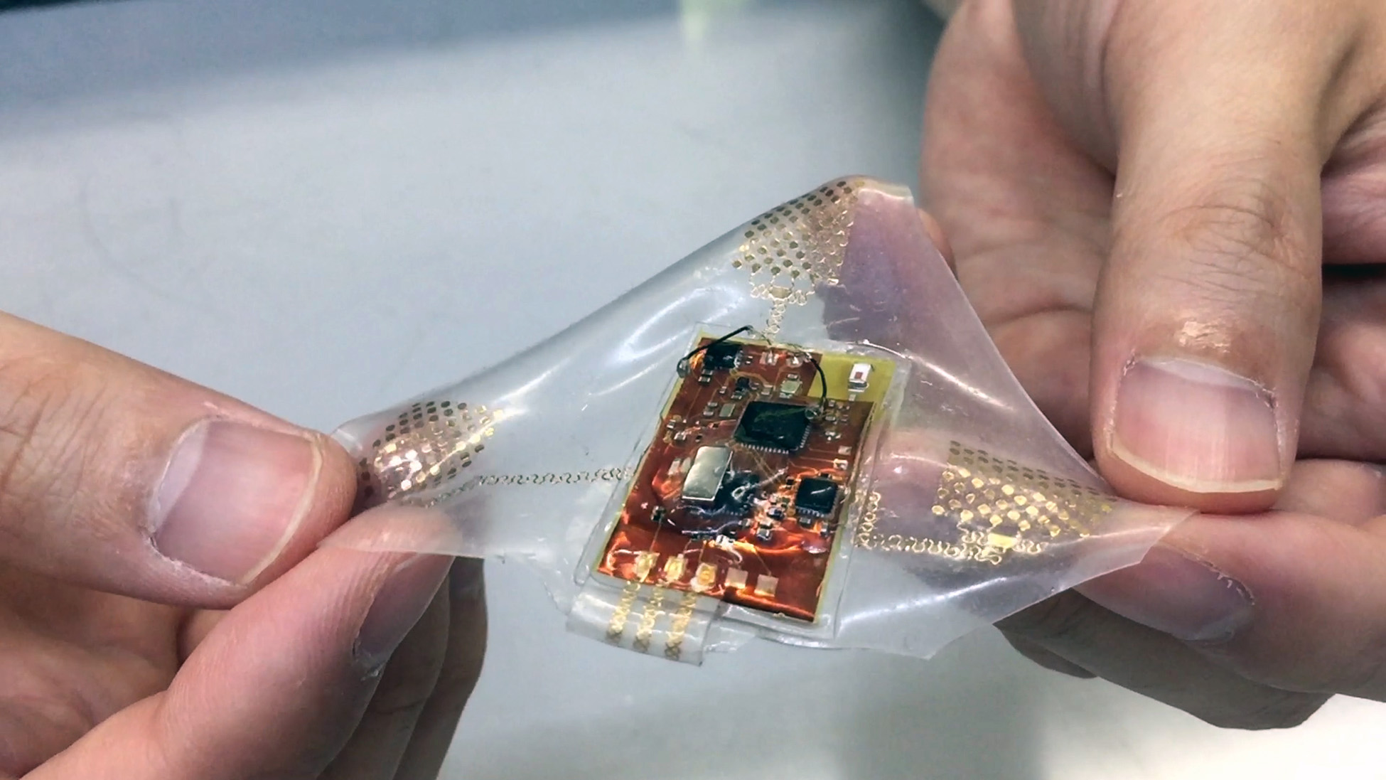 A wireless, wearable monitor built with stretchable electronics could allow comfortable, long-term health monitoring of adults, babies and small children. (Photo: John Toon, Georgia Tech)