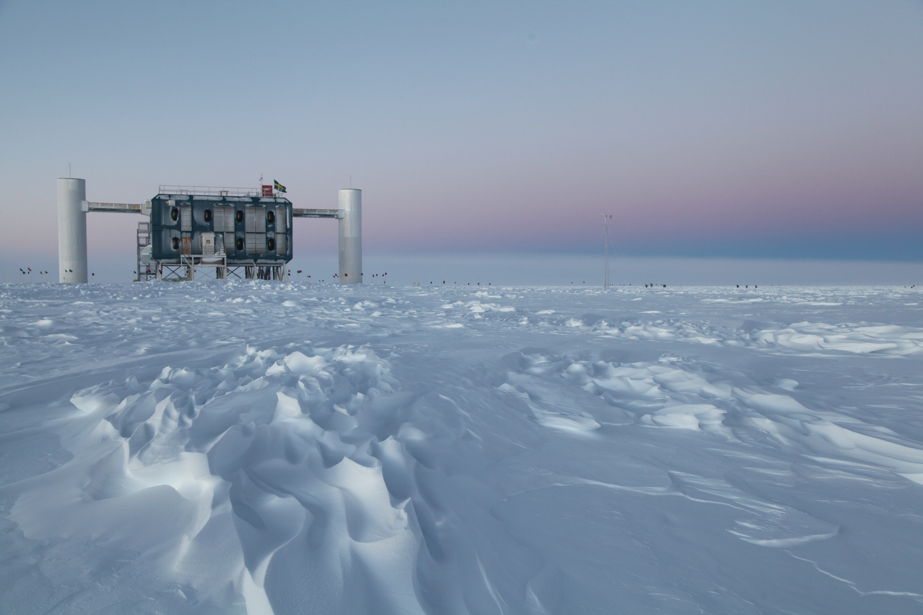 The IceCube Observatory at the Amundsen-Scott South Pole Station, in Antarctica, hosts the computers collecting raw data. Due to satellite bandwidth allocations, only certain data can be sent to the University of Wisconsin-Madison for further analysis. (Credit: Sven Lidstrom)