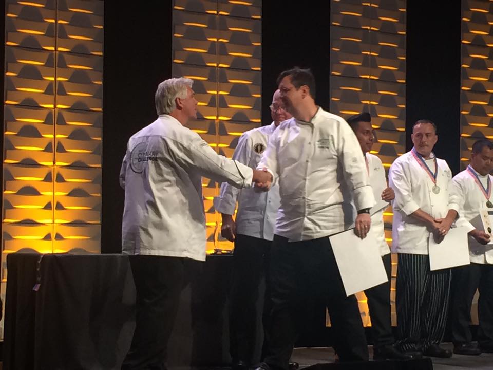 Chef Elwell accepting silver award at National Association of College and Univeristy Food Service Competition.