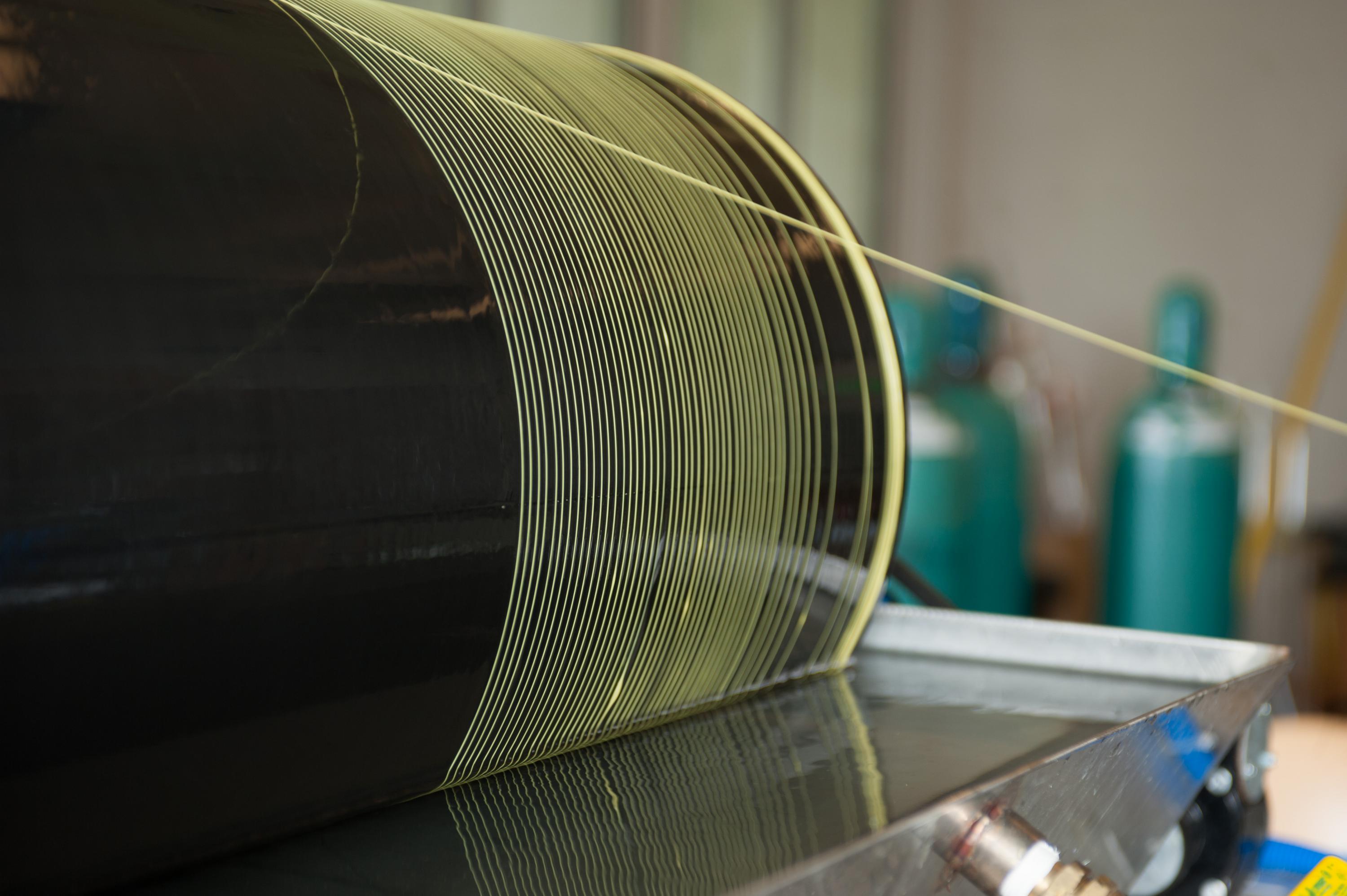 Photo shows the manufacture of polymer hollow fiber membranes, which are precursors to more advanced carbon molecular sieve hollow fiber membranes. (Credit: Rob Felt, Georgia Tech)