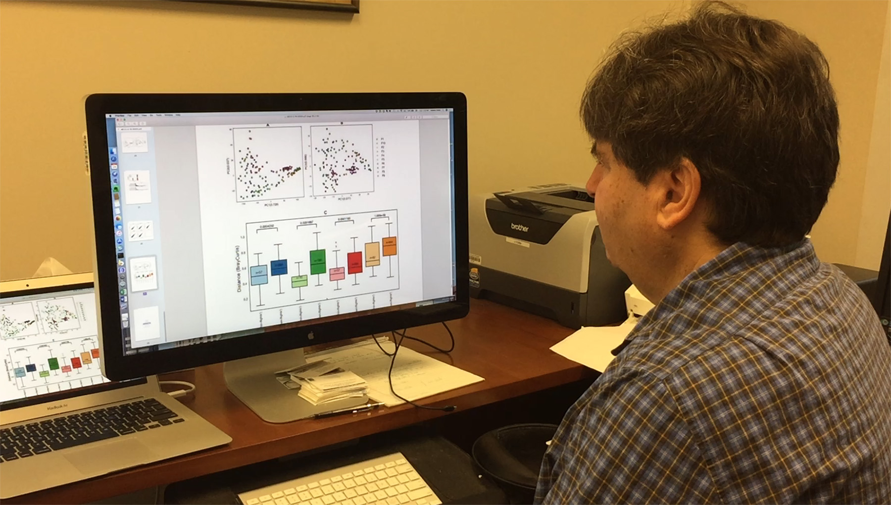 Georgia Tech Professor Howard Weiss reviews data about bacteria found on aircraft studied by a research team that sampled tray tables, seat belt buckles and the handles of lavatory doors. (Credit: John Toon, Georgia Tech)

 