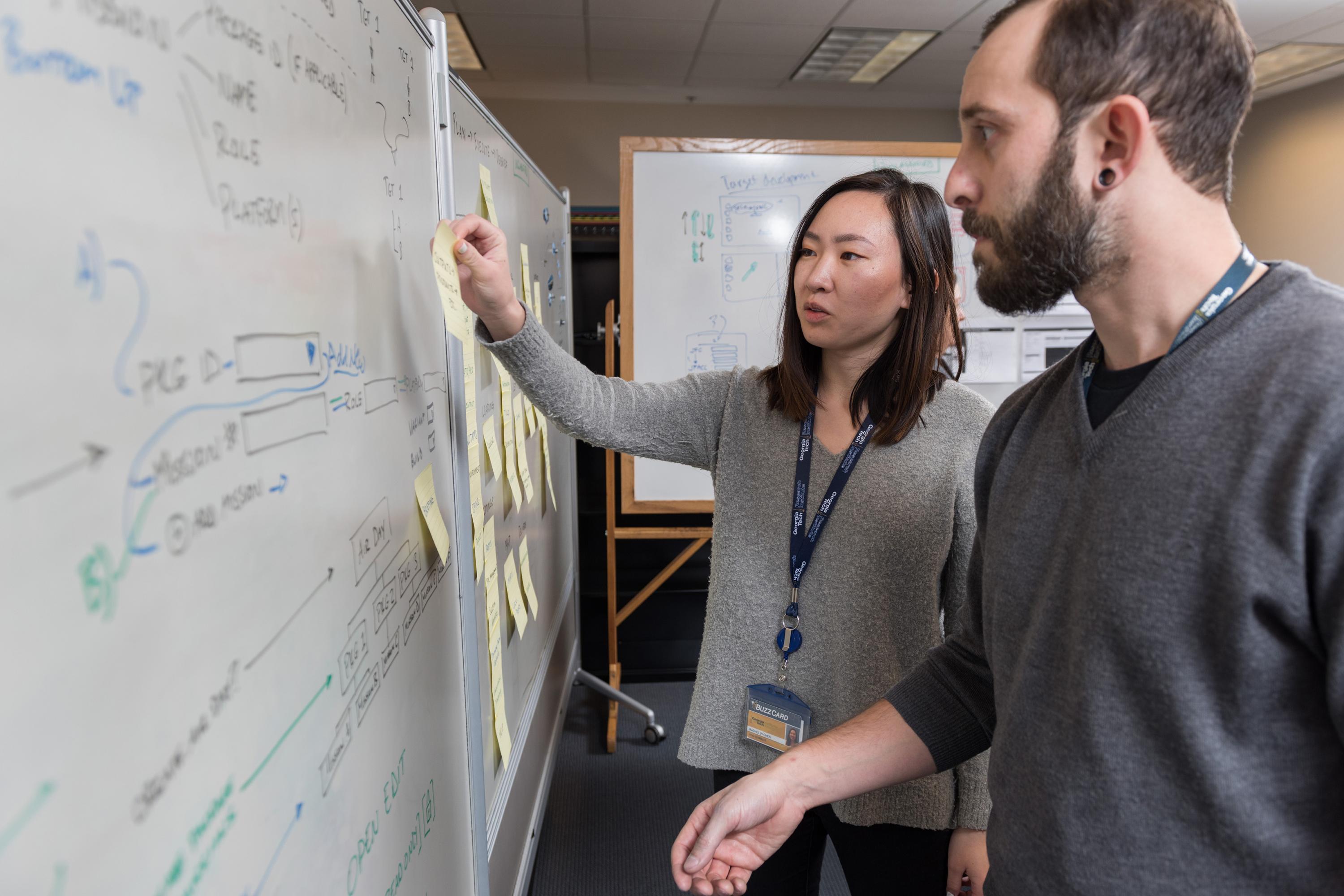 GTRI Research Scientist Andew Baranak and Georgia Tech Graduate Student Rachel Chen discuss creating user interface workflows for the mission planning task. (Credit: Rob Felt, Georgia Tech)