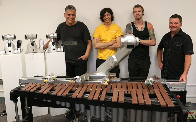 The Shimi robots, left, Shimon, front, and from left, Gil Weinberg, Mason Bretan, Jason Barnes and Chris Moore.