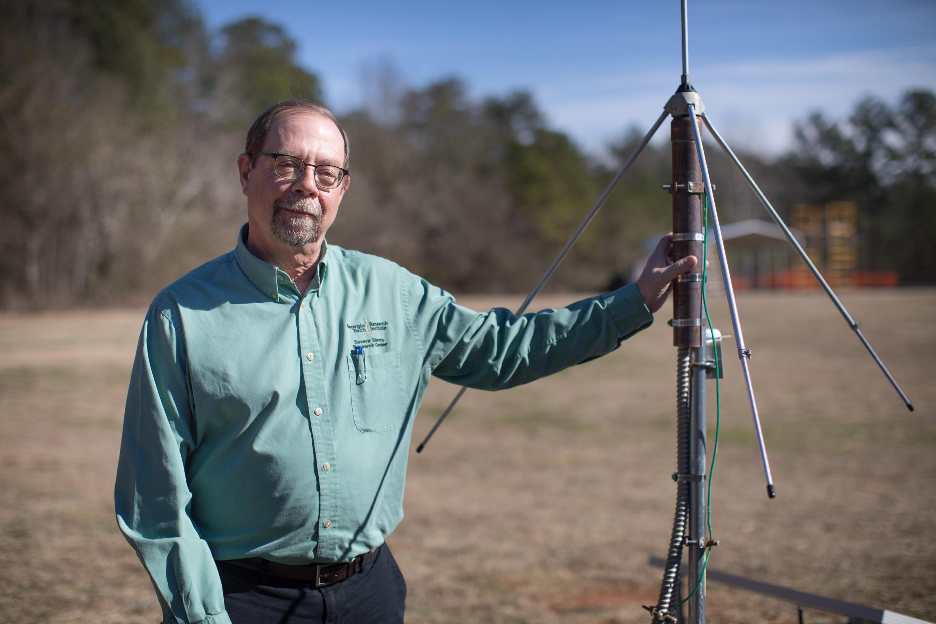 John Trostel, director of the Severe Storms Research Center (SSRC), poses with a sensor that is part of the North Georgia Lightning Mapping Array, a network of 12 such sensors located around the metropolitan Atlanta area to detect lightning that may indicate storm intensification. (Credit: Branden Camp, Georgia Tech Research Institute)