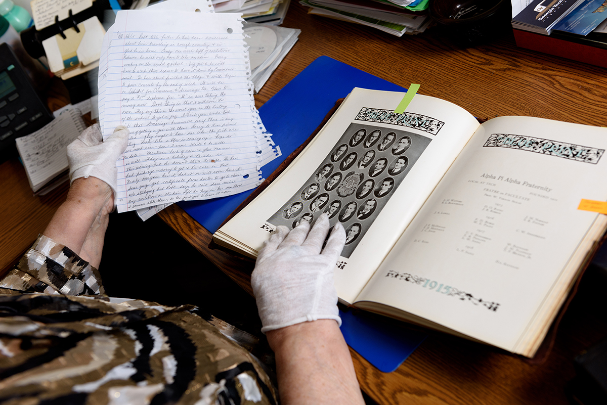 Marilyn Somers reviews her notes taken from vintage letters and the 1915 Blueprint, wearing gloves to protect the delicate documents she peruses on a regular basis.