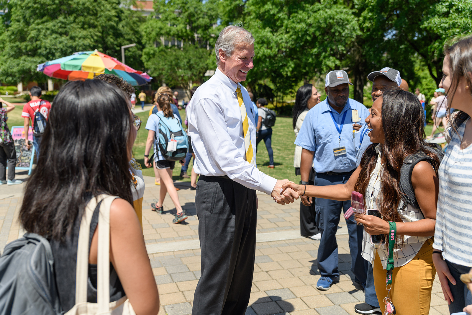 peterson shakes hands with a student