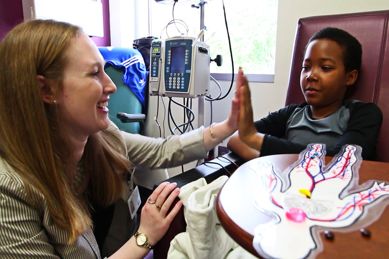 Volunteer working with sick child