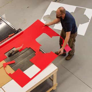 A man using a machine in the Digital Fabrication Lab.