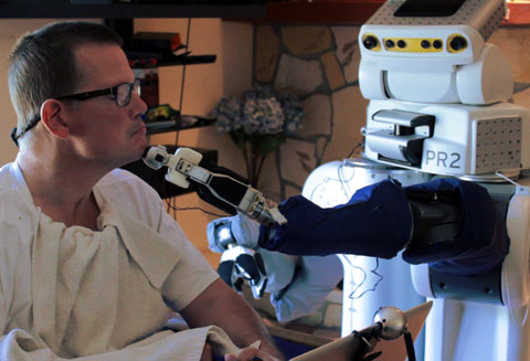 A robot shaves a man who has profound motor impairments.