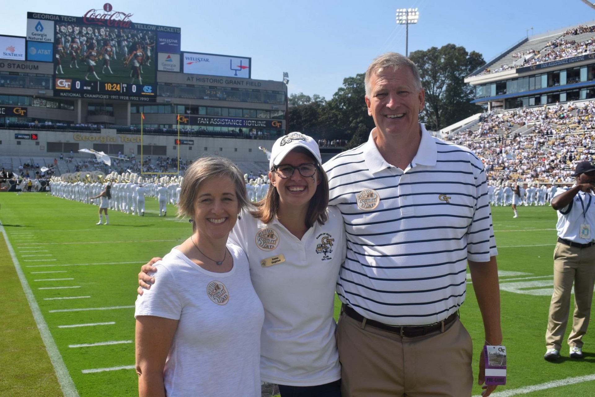 Emma Siegfried with her parents at a game