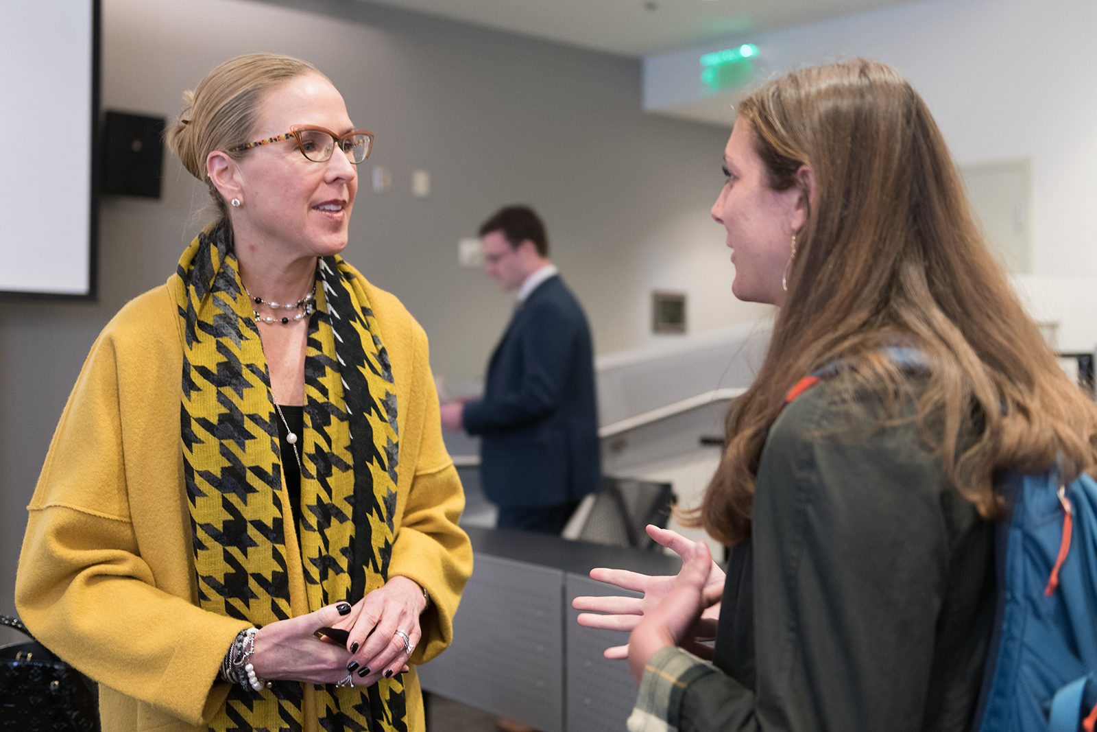 kelly barrett talks with student