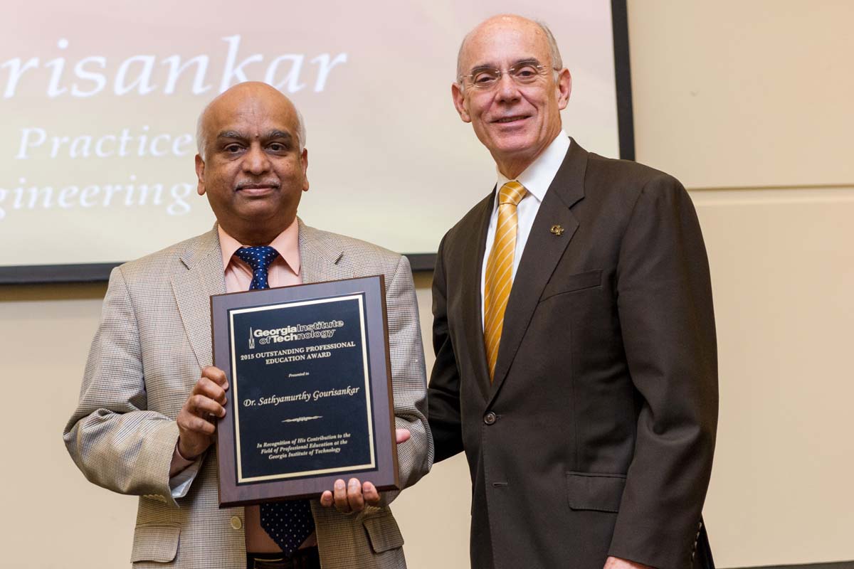 Provost Bras presenting award to faculty member on stage