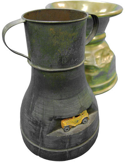 The two parade trophies: a simple brass spittoon in the back, and a metal vase with a tiny inset wreck in the front