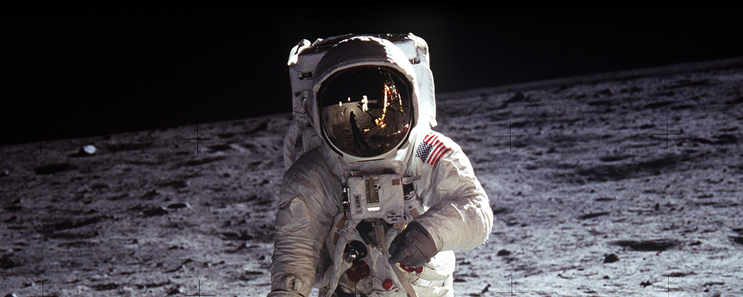Buzz Aldrin with a stark American Flag reflection in his helmet
