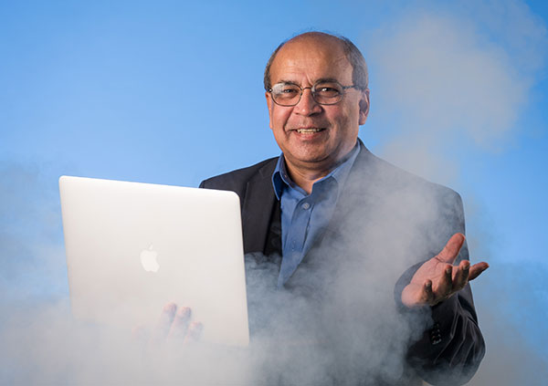 Ashok Goel at a computer surrounded by mist