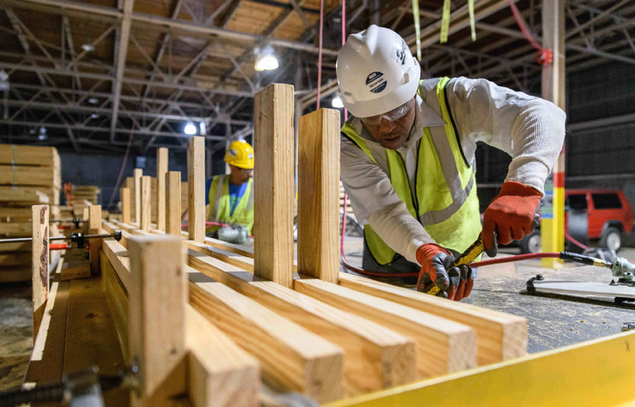 Workers preparing wooden building components for the Living Building