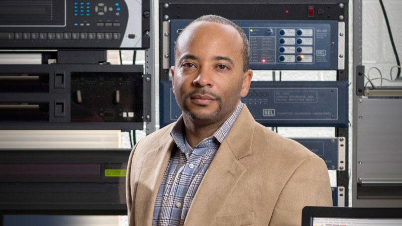 Raheem Beyah in front of computer hardware