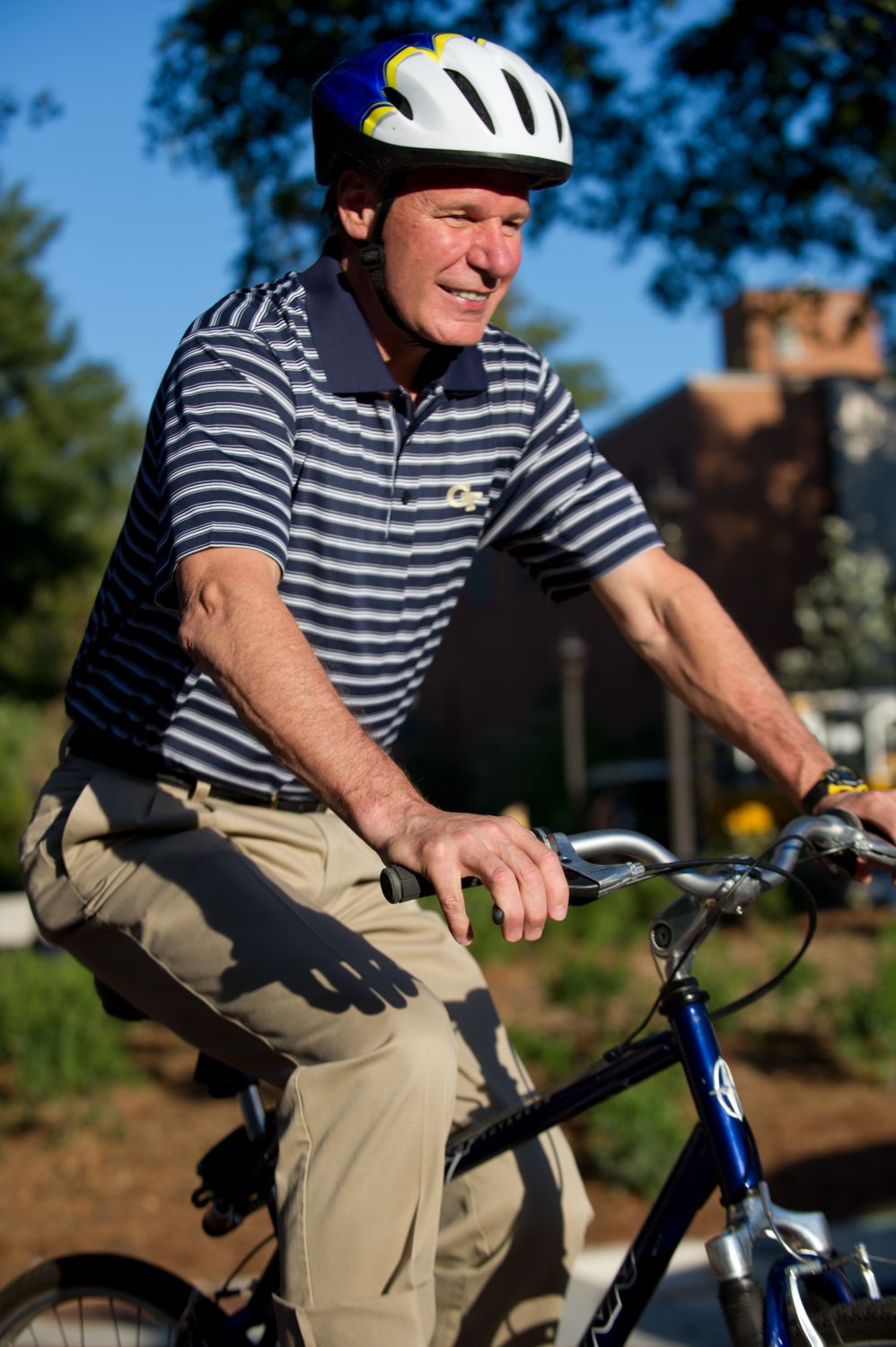 President G.P. "Bud" Peterson demonstrates proper use of a helmet while riding his bike