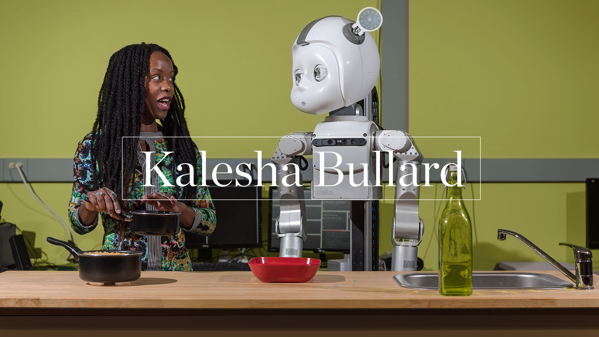 photo -  Kalesha Bullard in kitchen setting looking at robot