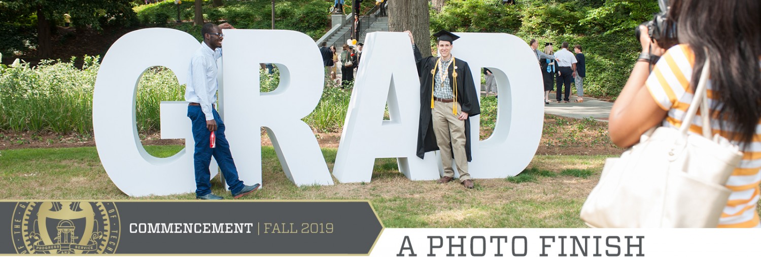 graduates with GRAD letters