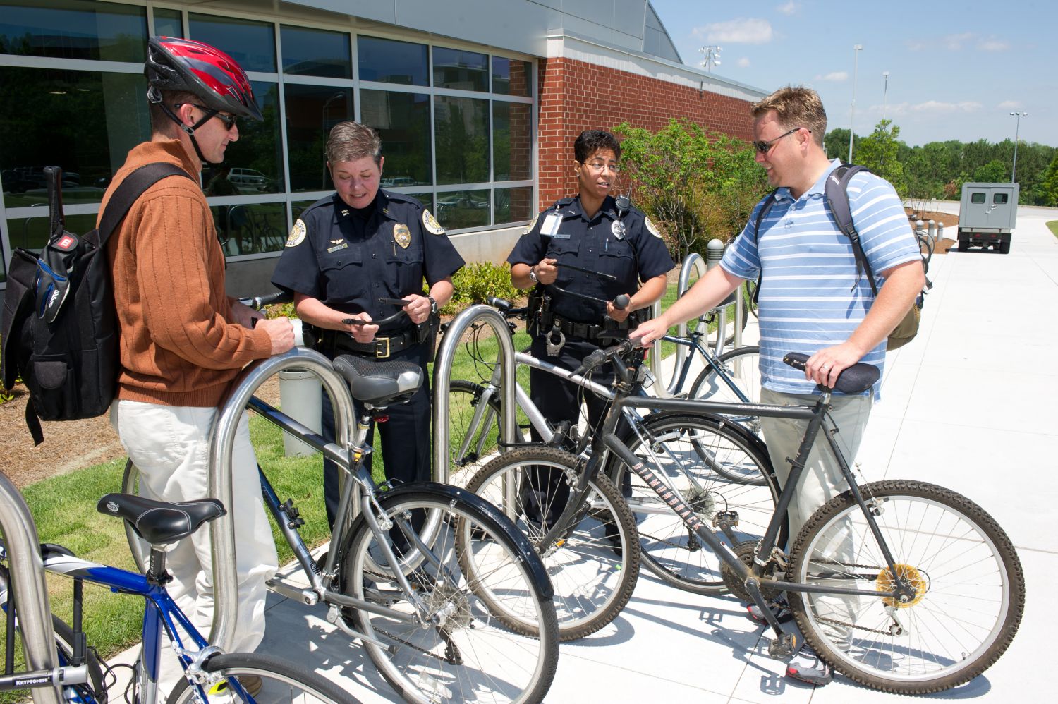 Georgia Tech police officers demonstrate the use of a U-lock to secure bikes