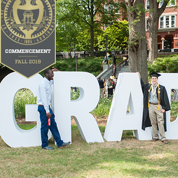 graduates with GRAD letters